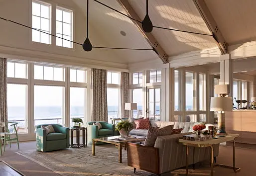 Light-filled living room with expansive windows overlooking the water